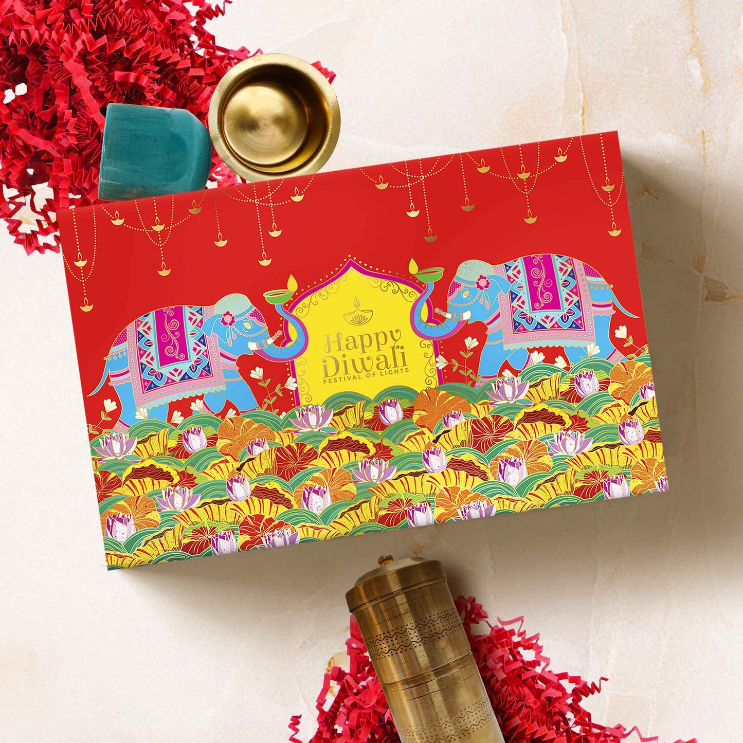 Close-up of brass dabara coffee set and ceramic speckle mugs in Diwali coffee hamper