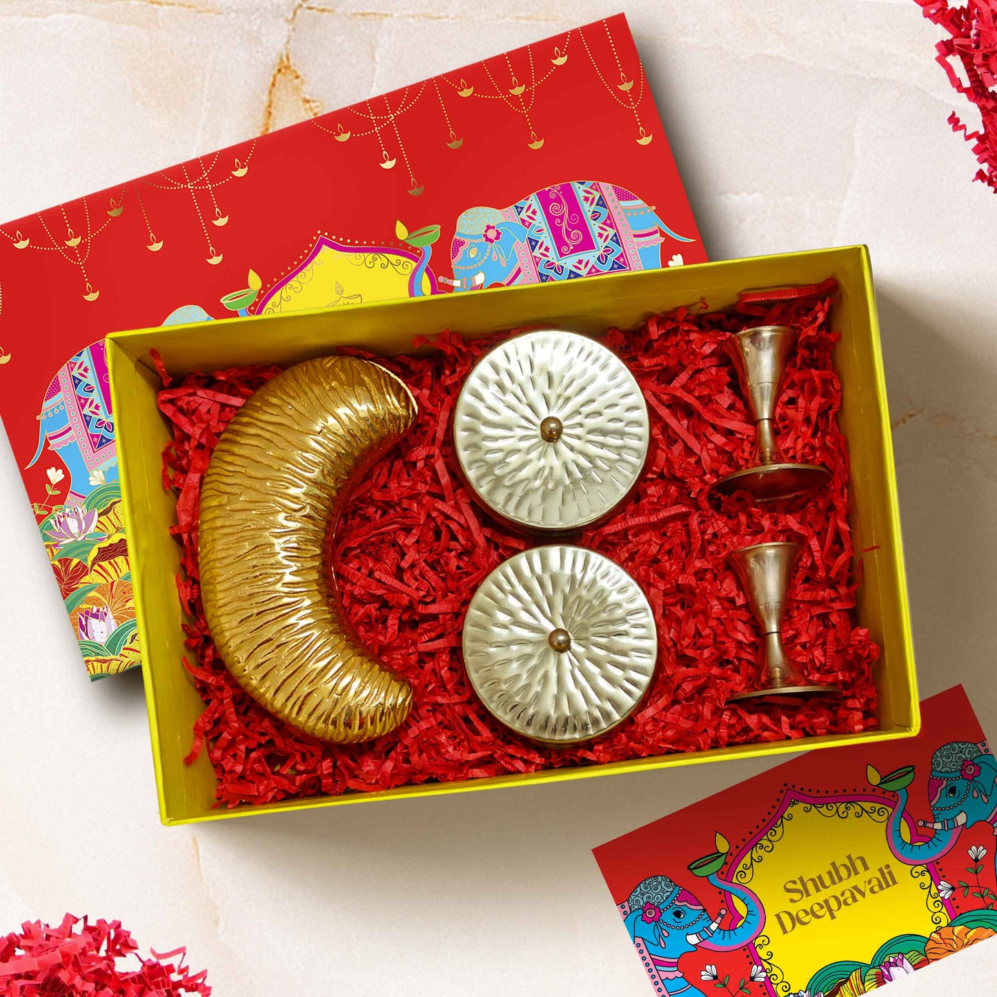 Luxury Opulence Box Diwali gift hamper with brass candle stands, cashew platter, chocolates, almonds in designer jars