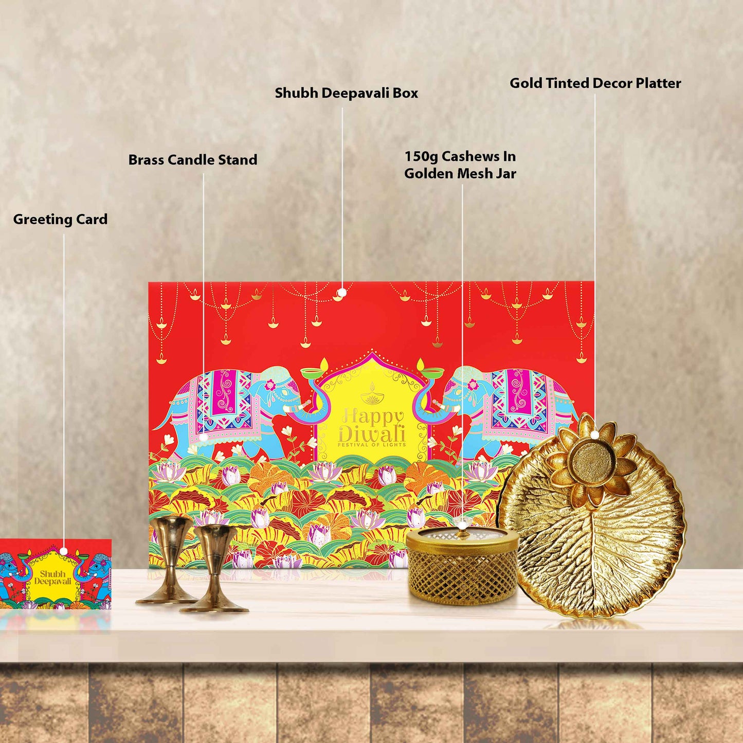 Open Celestia hamper with handcrafted brass thali platter, brass candle stand set, and golden mesh jar of cashews