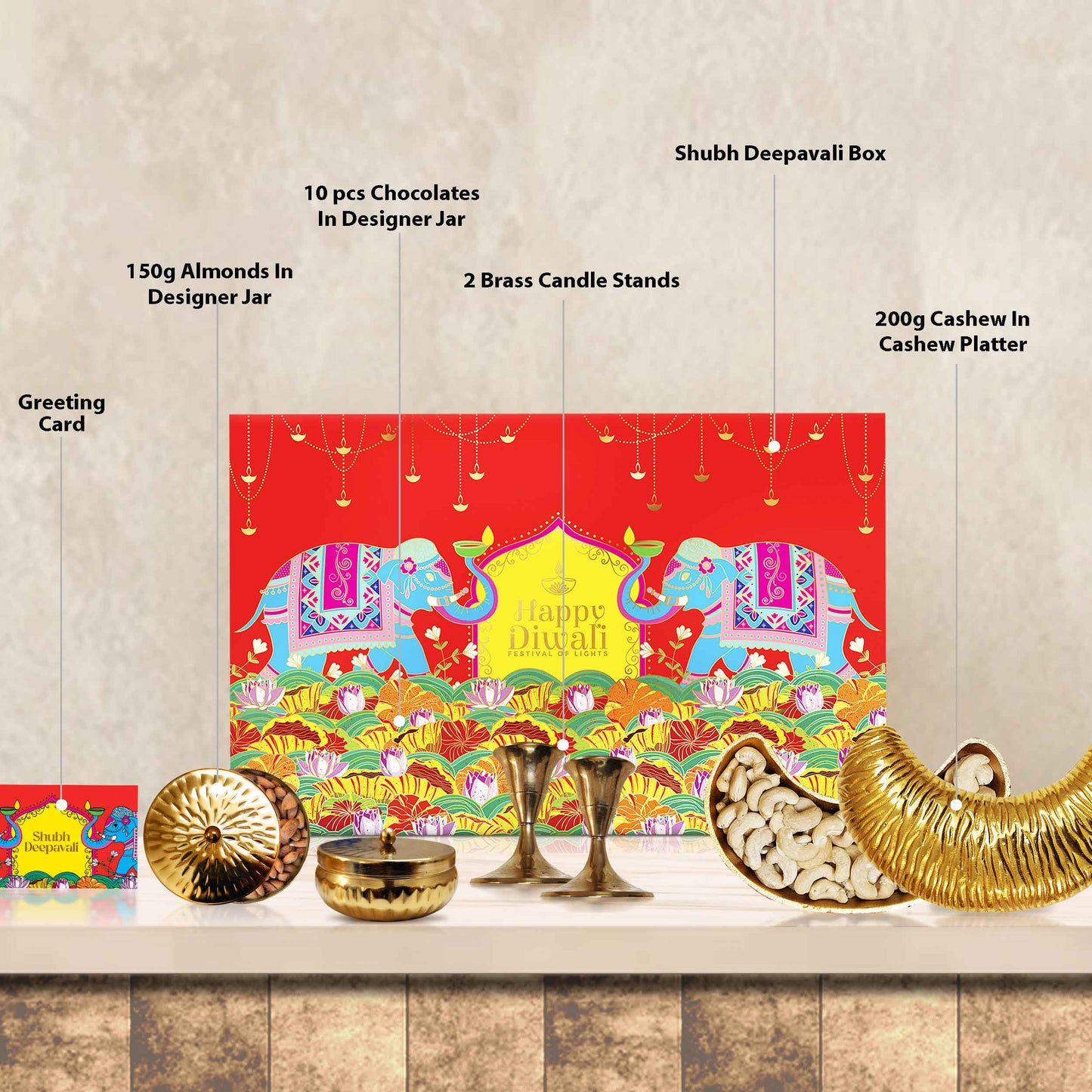 Open view of Opulence Box showing brass cashew platter, brass candle stand set, and festive treat jars