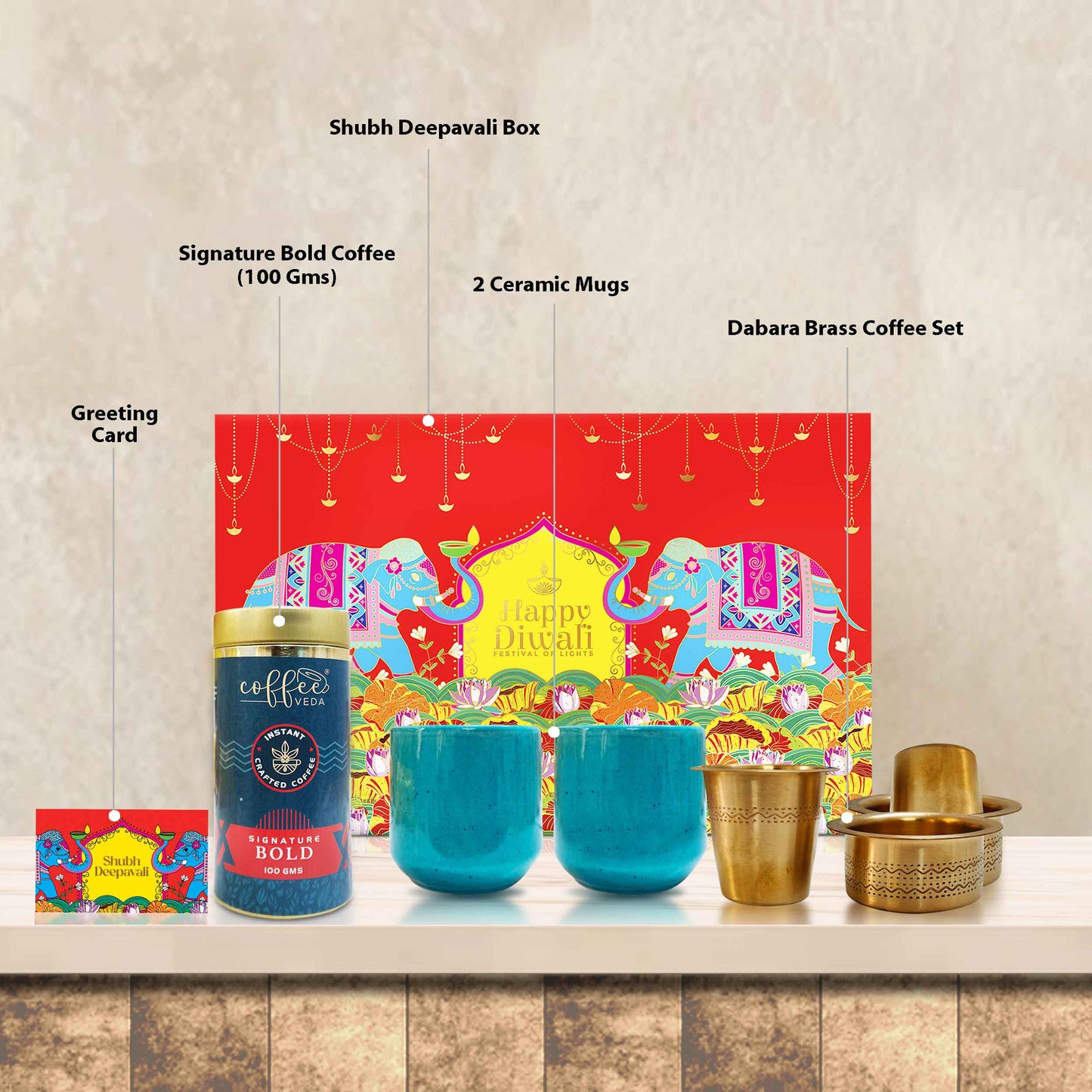 Open Luxury Coffee Delight Box showing artisan brass coffee filter, bold coffee, and speckled ceramic mugs inside