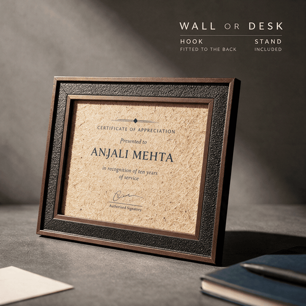 Jute fibre certificate of appreciation frame standing on a desk beside a notebook and pen, showing it works on a wall or a desk