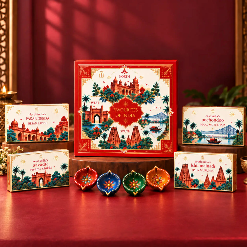 Favourites of India red illustrated gift box with four regional snack boxes and painted clay diyas in red, blue, green and orange displayed in front