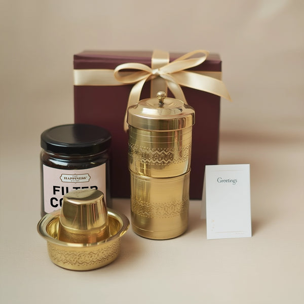 Gold tea canister set with a gift box and card on a neutral background