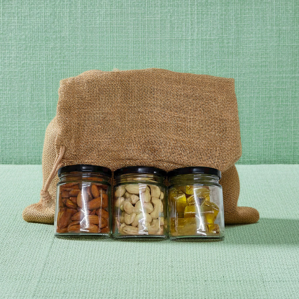 Premium compact jute hamper with almonds, cashews, chocolates, and festive wishes card.