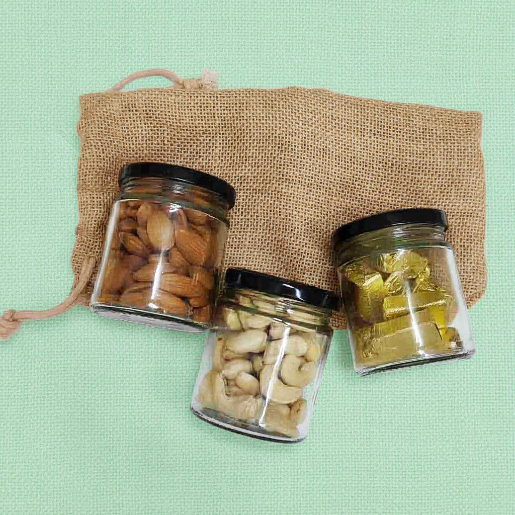 The Happiness Bag – jute pouch hamper with 3 glass jars of almonds, cashews, and chocolates.