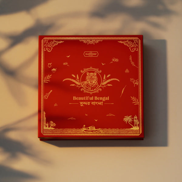 Beautiful Bengal Box open — Darjeeling First Flush Tea tin, Masala Muri, Khasta Nimki, Chanachur, Sunderban Honey and Mango Pickle inside