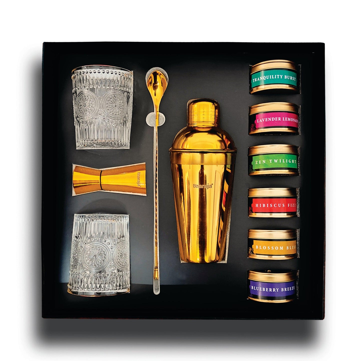 The Happiness Story Cocktail Kit open box showing six curated botanical infusions, cocktail shaker, and recipe guide