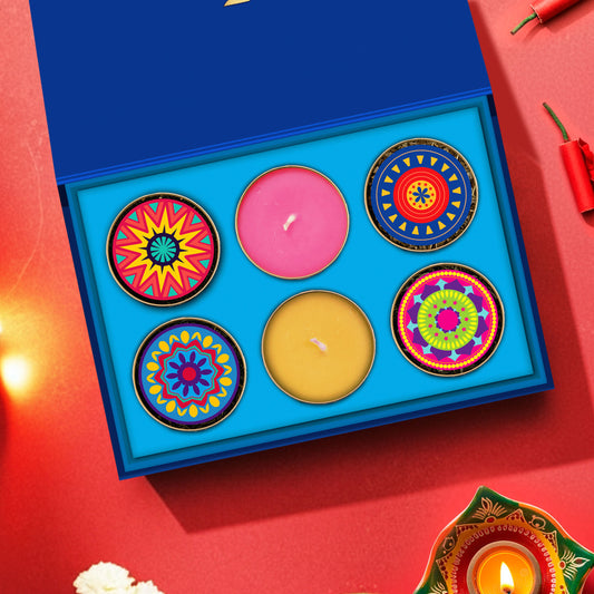 Diwali gift hamper – The Cracker Box by The Happiness Story, featuring 4 designer cracker-themed round tea tins and 2 hand-poured scented candles in a premium blue festive box.