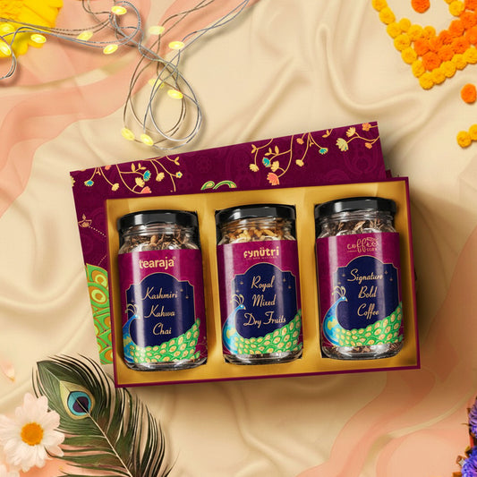 Peacock Diwali Box opened displaying three glass jars – Kashmiri Kahwa Chai, Signature Bold Coffee, and Mixed Dry Fruits – along with Happy Diwali card in gold-foiled themed packaging.”