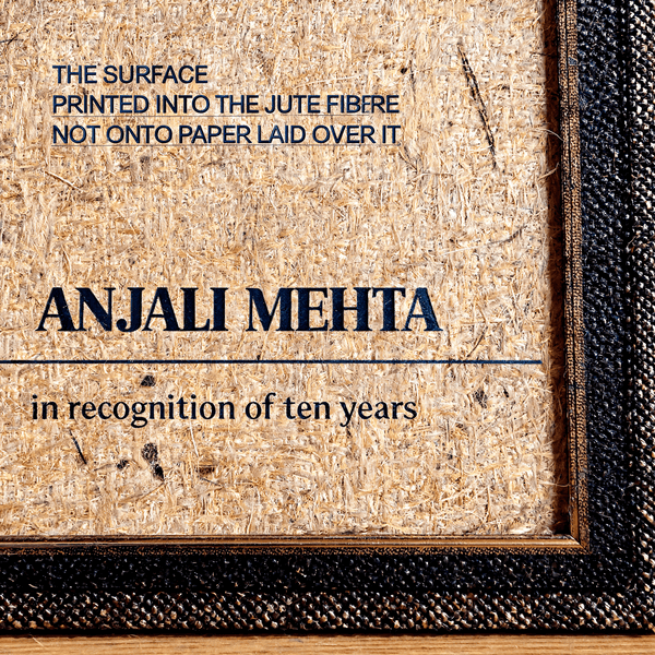 Close-up of a certificate printed directly into natural jute fibre board, showing individual fibres and flecks running through the lettering