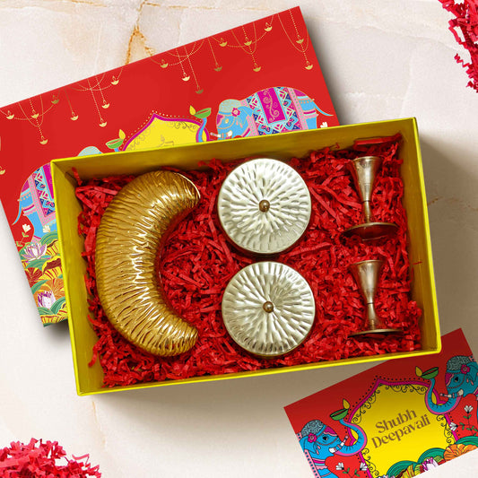 Luxury Opulence Box Diwali gift hamper with brass candle stands, cashew platter, chocolates, almonds in designer jars