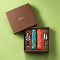 Overhead view of the open jamawar shawl and wine glass gift hamper with both shawls rolled into the fitted tray and both glasses in their recesses