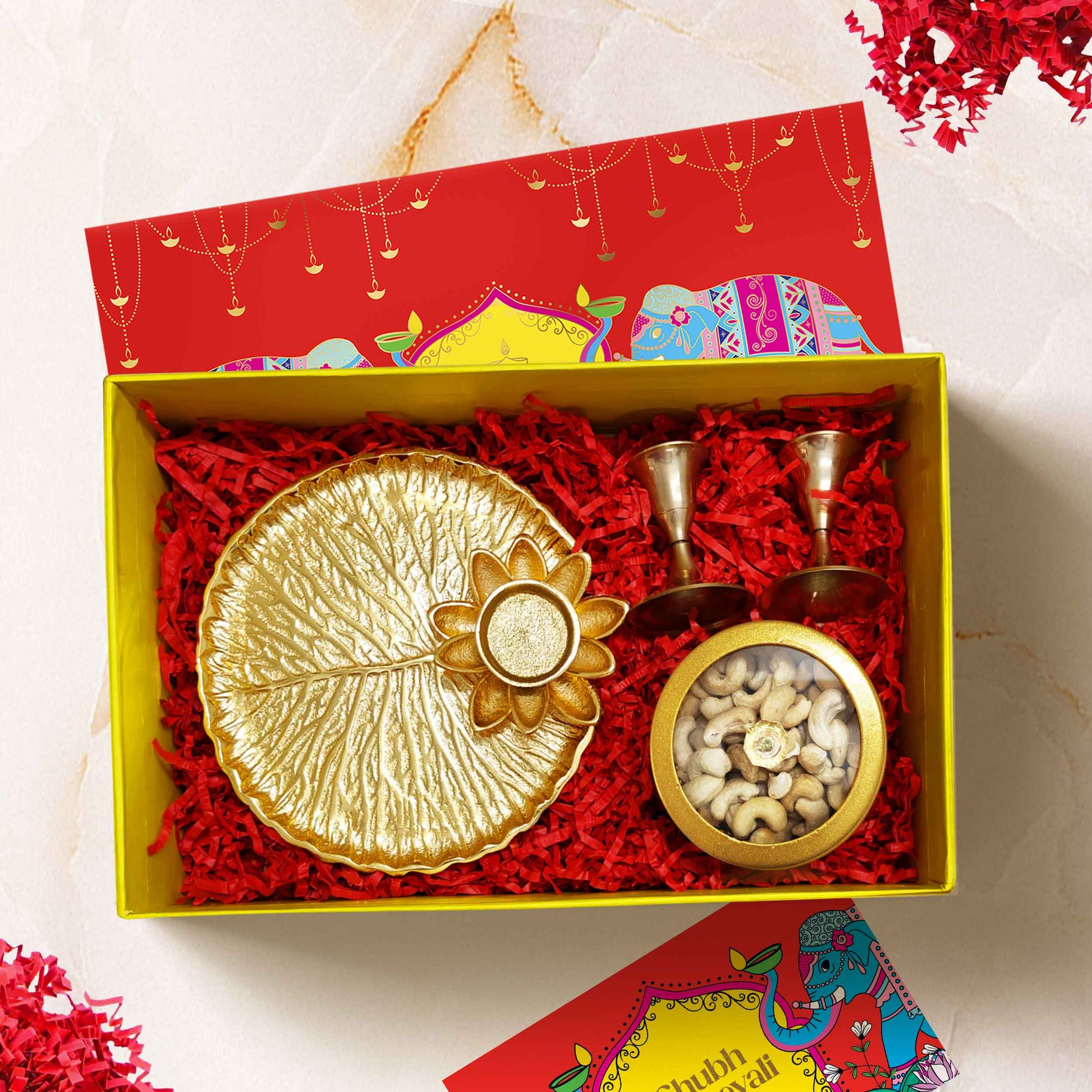 Luxury Celestia Box Diwali gift hamper with brass candle stands, gold-tinted puja thali, and premium cashews