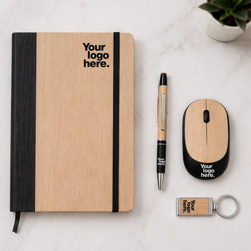 Bamboo wireless mouse gift set flat lay with bamboo notebook, pen and keychain — sustainable work from home desk gift set with logo
