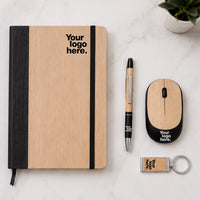 Bamboo wireless mouse gift set flat lay with bamboo notebook, pen and keychain — sustainable work from home desk gift set with logo