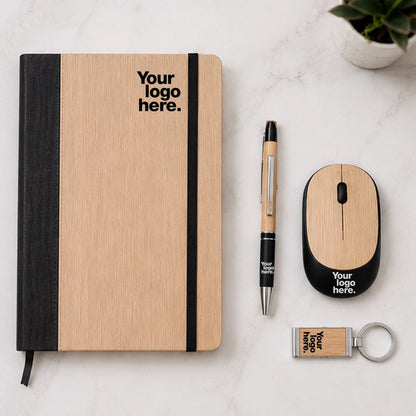 Bamboo wireless mouse gift set flat lay with bamboo notebook, pen and keychain — sustainable work from home desk gift set with logo