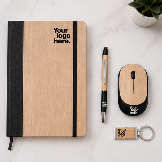 Bamboo wireless mouse gift set flat lay with bamboo notebook, pen and keychain — sustainable work from home desk gift set with logo