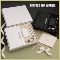 White and black employee welcome kits with debossed logo notebooks, card holders, pens and keychains in rigid gift boxes