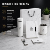 Signature Business marble executive gift set styled on desk — white insulated bottle, marble notebook, insulated mug, keychain and metal card holder with gift bag