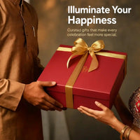 Two people exchanging a ribboned red Diwali gift box, with the words Illuminate Your Happiness across the frame