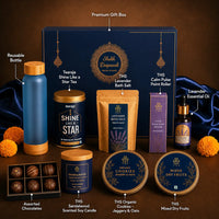 Labelled contents of the Diwali wellness hamper — premium gift box, reusable bottle, skin glow tea, lavender bath salt, calm pulse point roller, lavender essential oil, assorted chocolates, sandalwood scented soy candle, organic jaggery and oat cookies and mixed dry fruits
