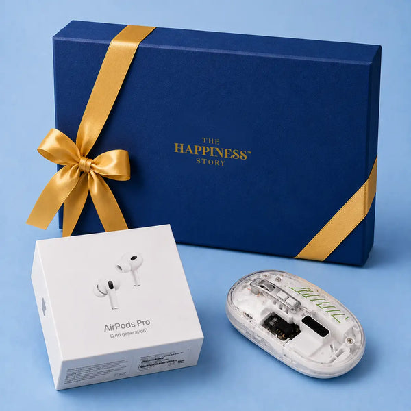 Closed navy gift box tied with a gold satin ribbon and stamped with a gold foil logo, with a sealed AirPods Pro carton and a transparent wireless mouse set out in front