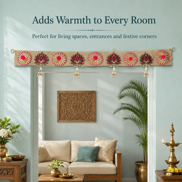 Jute lotus toran hung above a living-room doorway in daylight, with a cream sofa, a palm and a lit brass lamp beyond