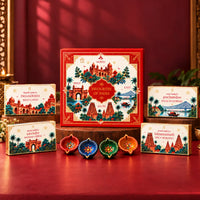 Favourites of India red illustrated gift box with four regional snack boxes and painted clay diyas in red, blue, green and orange displayed in front