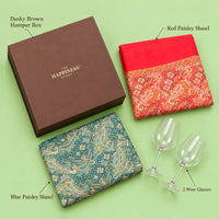 Labelled contents of the shawl and wine glass gift hamper — dusky brown hamper box, red paisley shawl, blue paisley shawl and 2 wine glasses