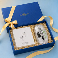 Navy kappa board gift box open at an angle with its lid behind, packed with sealed AirPods Pro and a transparent wireless mouse seated side by side on kraft shred