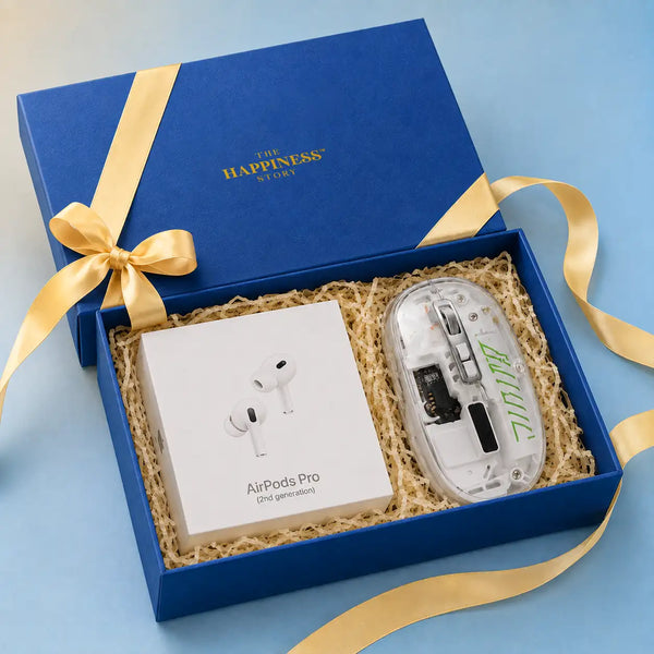 Navy kappa board gift box open at an angle with its lid behind, packed with sealed AirPods Pro and a transparent wireless mouse seated side by side on kraft shred