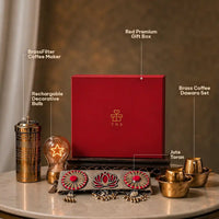 Labelled contents of the brass Diwali hamper: red keepsake box, etched brass coffee filter, rechargeable star bulb, dabara tumbler and bowl pair and jute toran