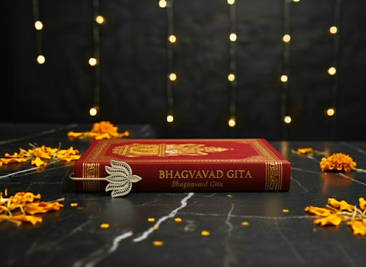 Silver Lotus Bookmark placed in Bhagavad Gita, symbol of knowledge and Saraswati.