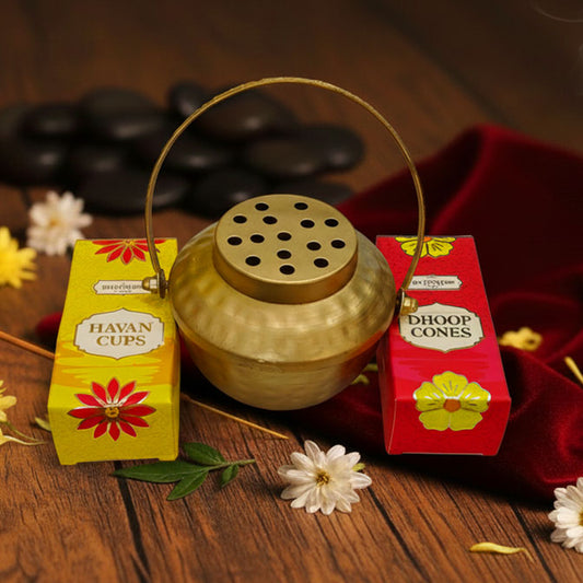 Golden aluminium loban burner lit with smoke, paired with havan cups and dhoop cones for festive pooja essentials and Diwali gifting.