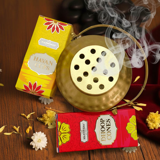 Gold round aluminium loban burner with handle, burning natural dhoop cone for pooja rituals and Diwali décor.