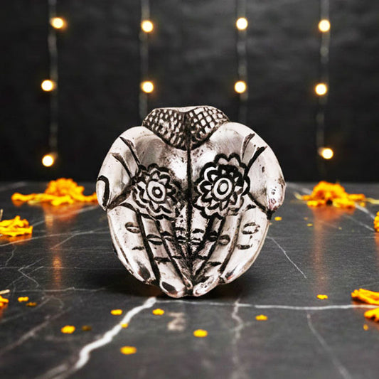 Close-up of antique silver Hand Diya showcasing intricate handcrafted details