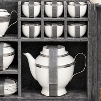 Close-up inside the Royal Majesty trunk — silver-plated cups and plates in fitted velvet settings