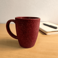 Rice husk coffee mug holding a hot drink on an uncluttered work desk